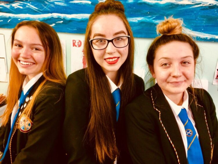 Andromeda Gibb, Hannah Gillespie and Kayleigh Colgan smile for the camera in school uniform. 