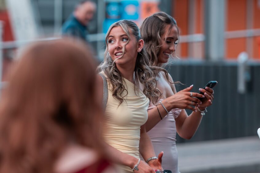 Pupils head into the hotel in their prom dresses