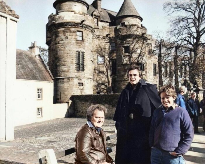 Johnny Cash and his son with farmer John Duncan outside Falkland Palace in Fife