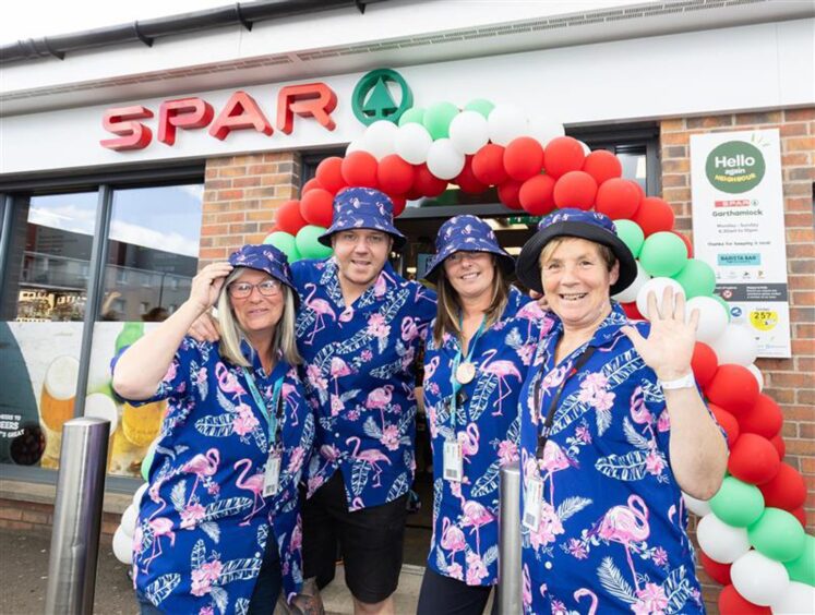 Staff in fancy dress outside a SPAR store. 
