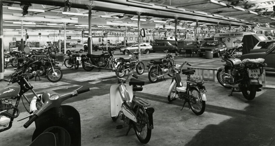 motorbikes in the foreground and cars in the background at the event