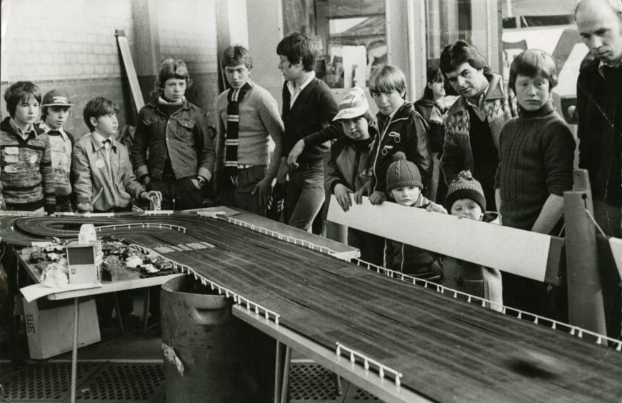 A crowd gathers to watch Scalextric at Dundee Motor Show in 1979