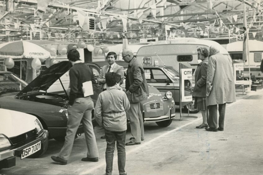Visitors inspect models at the 1983 event. 
