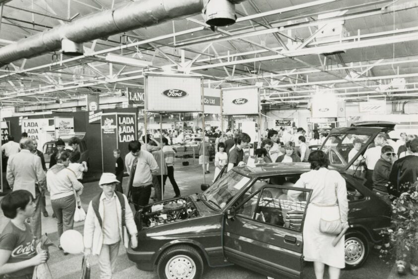 people at the Ford and Lancia stands in 1984.