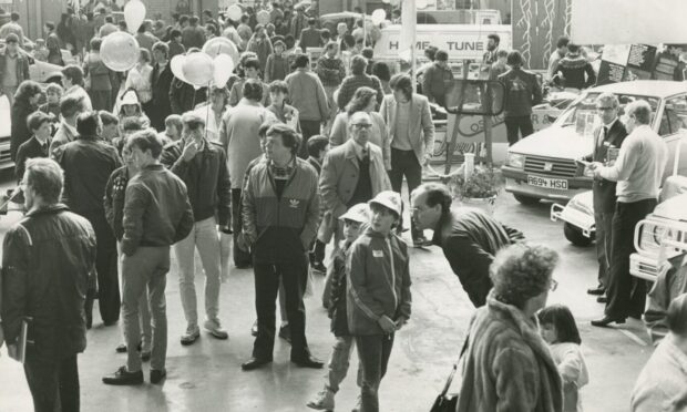 Crowds gathering round the vehicles indoors at the 1985 Dundee Motor Show.