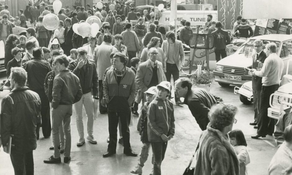 Crowds gathering round the vehicles indoors at the 1985 Dundee Motor Show.