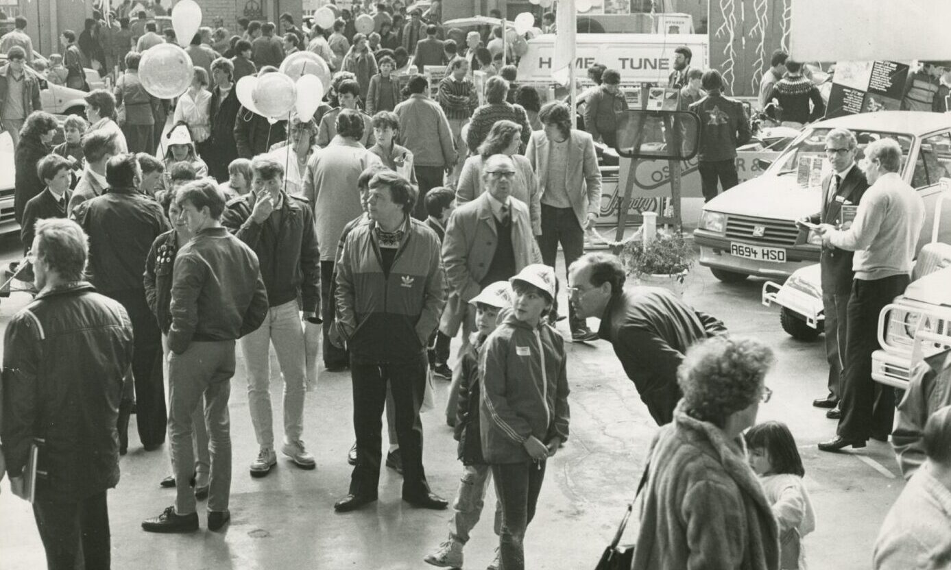 Crowds gathering round the vehicles indoors at the 1985 Dundee Motor Show.