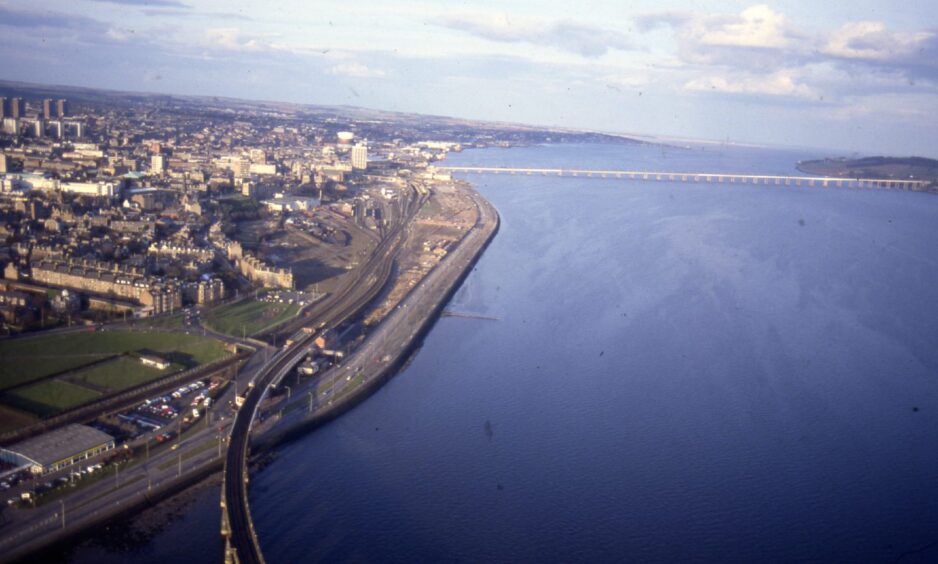 an aerial shot showing the Dundee cityscape, the River Tay and road and rail bridges in 1988