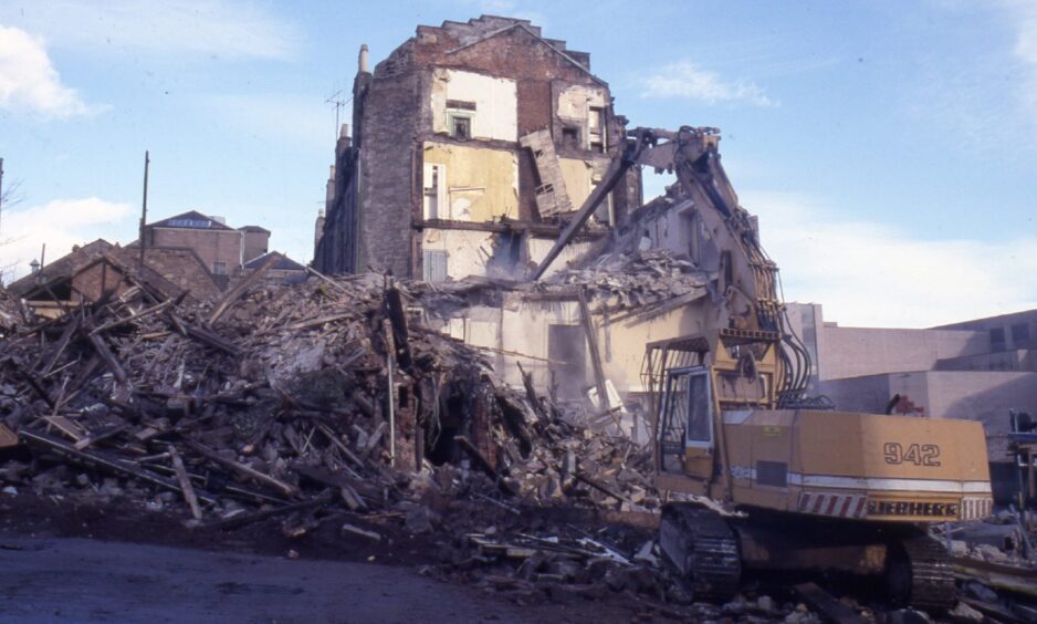 a digger and a huge pile of rubble as the two Dundee pubs are pulled down