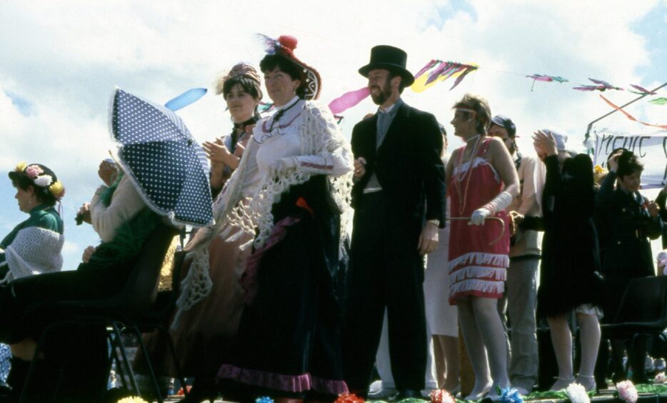 People in top hats partying at the festival in 1988.