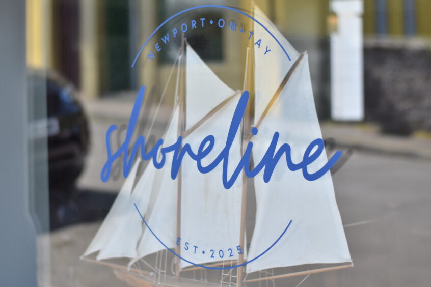 The Shoreline logo on a restaurant window.