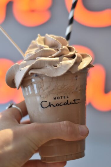 A person holding Hotel Chocolat's chocolate shake.