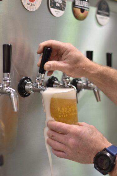 A person pouring a beer.