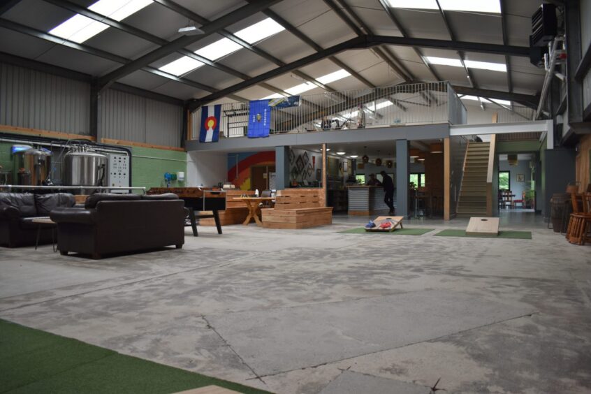 The spacious social hall prepared for games including cornhole.