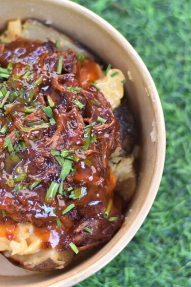 A close up image of a tattie topped with pulled pork.