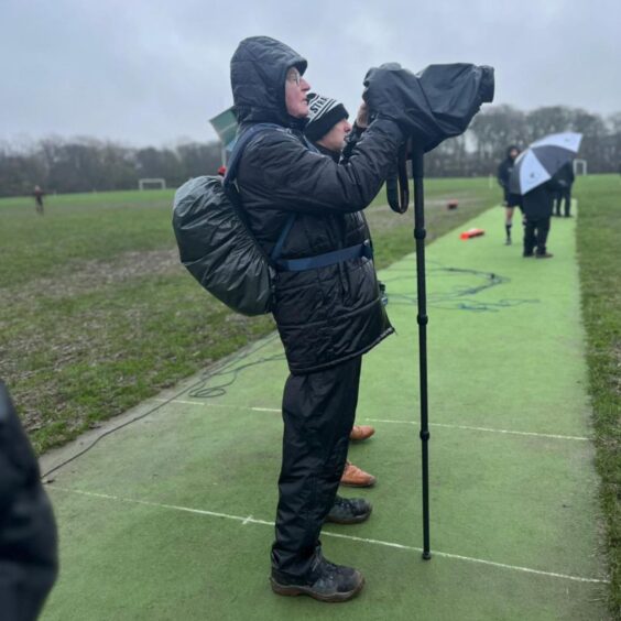 David Potter capturing the action from the rugby touchline with his trusty camera.