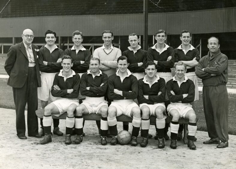 A suited George Anderson with his 1949 Dees side in the official team shot