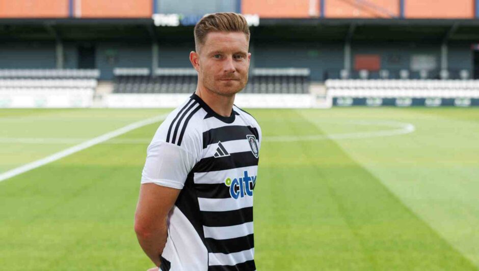 Euan Murray stands with his hands behind his back in a Queen's Park shirt.