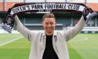 Euan Murray holds up a Queen's Park scarf.