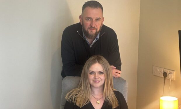 Franki and Barry posing at her desk