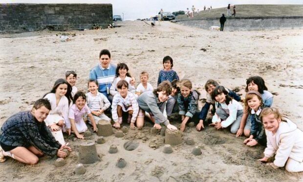 Children building sandcastles on Broughty Ferry beach in July 1987.