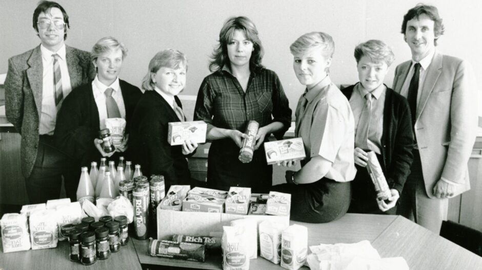Pupils hand the items, arranged on a table, to Community Contact for distribution