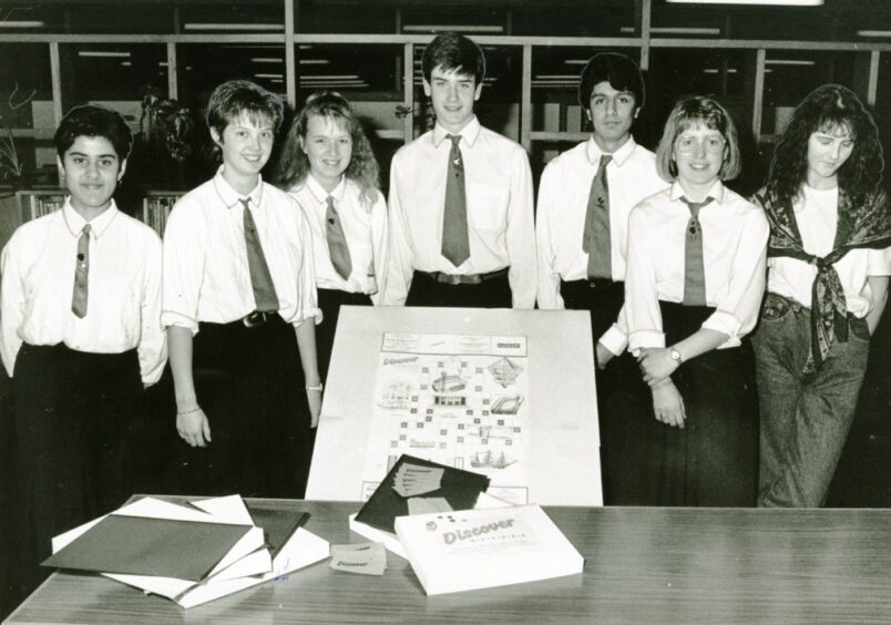 Pupils in front of a table with the Discovering Dundee game in 1988