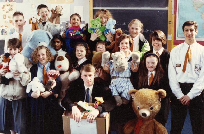 Pupils in a classroom with gifts for deaf Romanian children