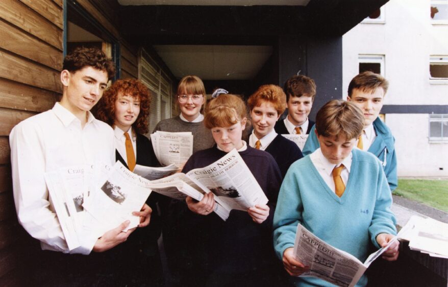  a teacher and pupils with copies of The Craigie News