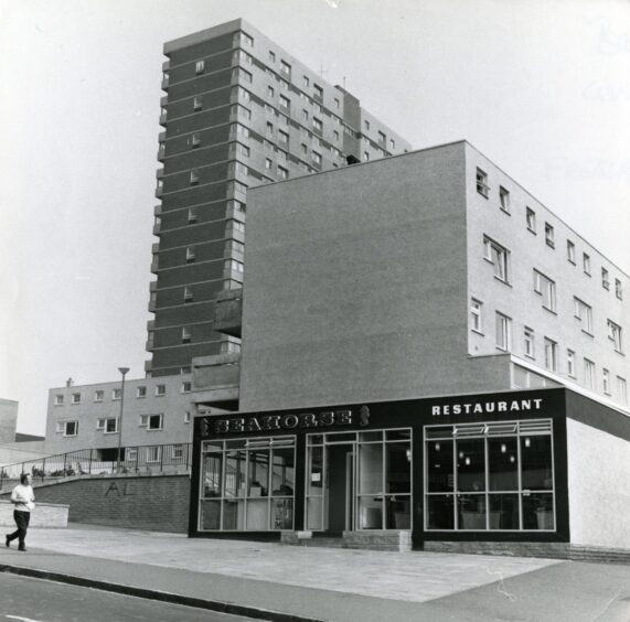 A man walking past the Seahorse chip shop at the Hilltown shopping complex in Dundee in 1973.