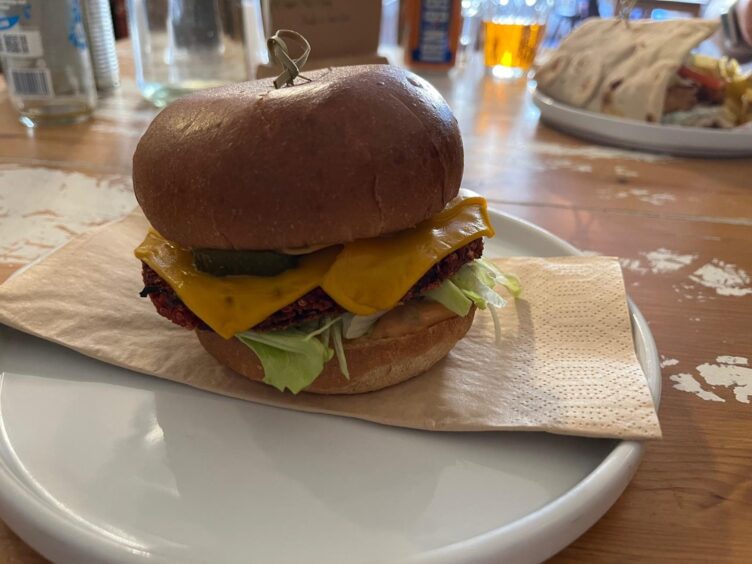 The beet burger served on a rimmed plate.