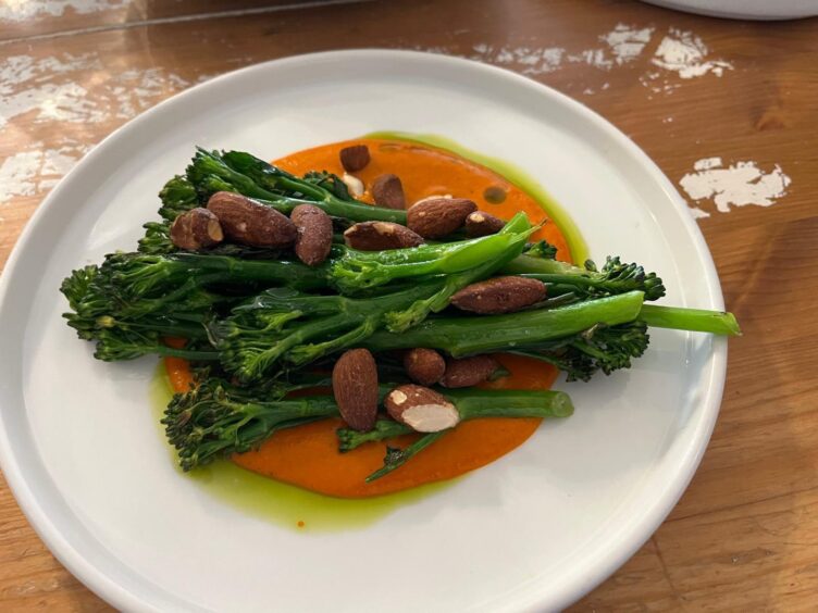 A plate of tenderstem broccoli and smoked almonds.