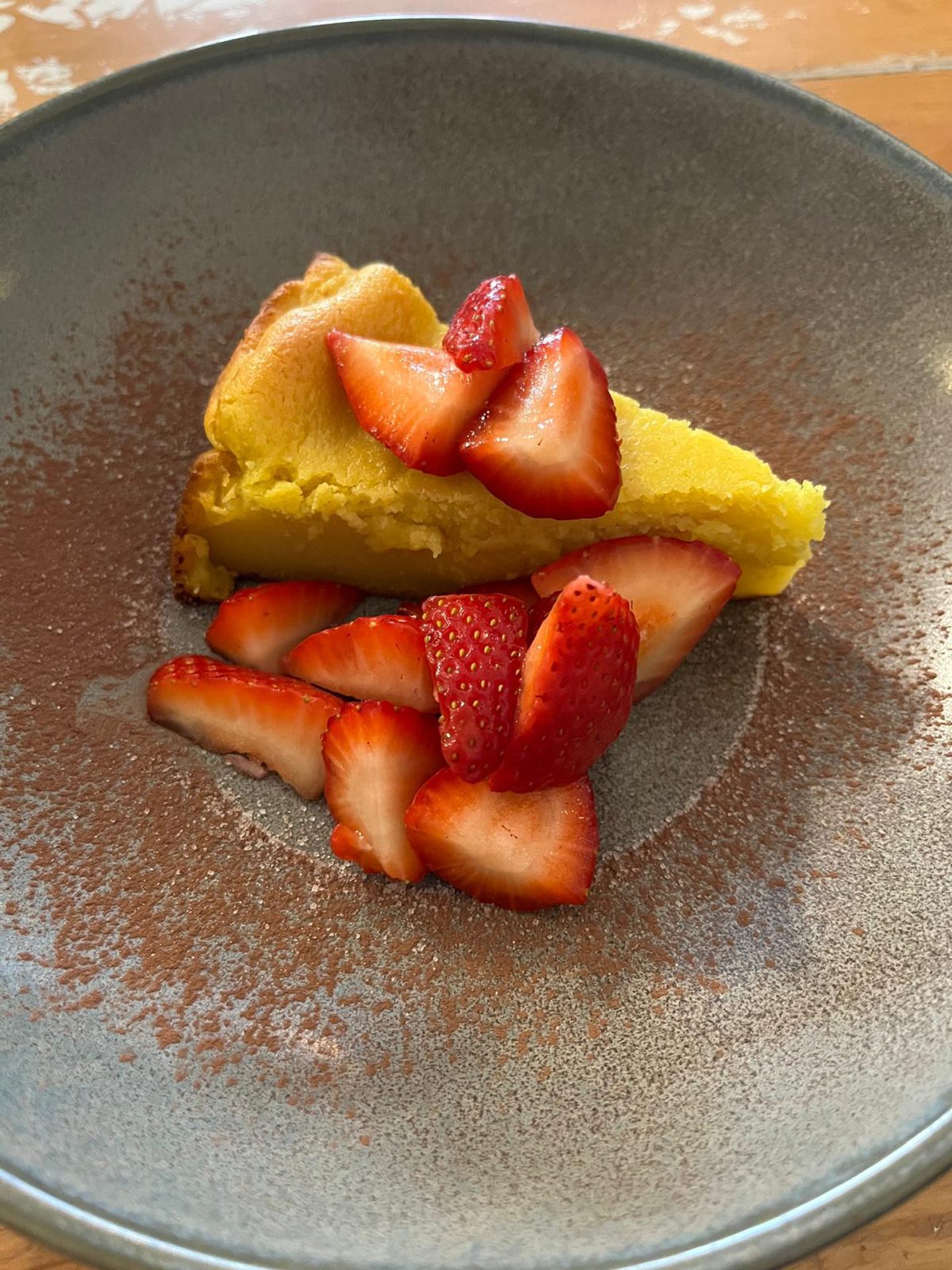 The Basque cheesecake served with quartered strawberries