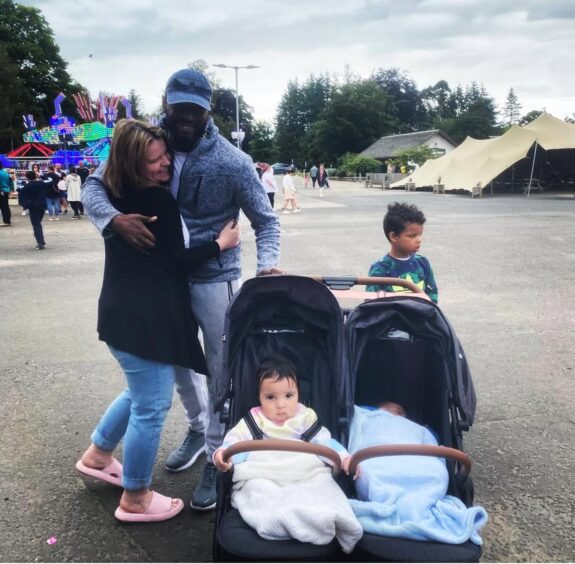Lesley with husband Victor, her son Leo and their children Niko and Nairobi outdoors. 