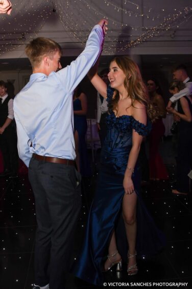 A boy and a girl dancing together. 