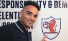 New signing Jai Rowe points to a Raith Rovers badge on the wall.