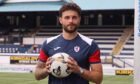 Raith Rovers signing Josh Rae stands clutching a ball at Stark's Park.