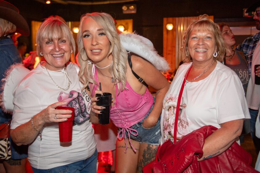 Women smiling in a nightclub. 