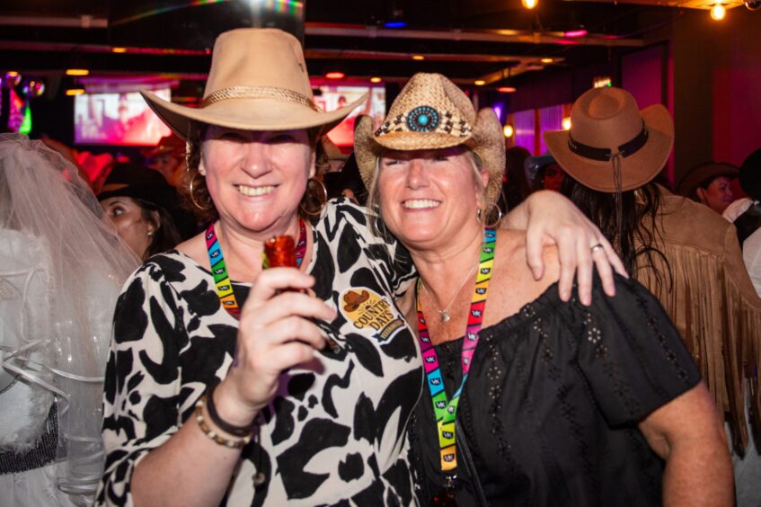 Women in cowboy hats in a nightclub. 