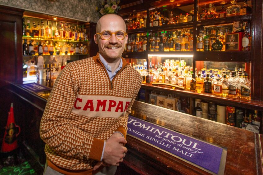 Jacob Smith standing next to the Star & Garter's whiskey bar.