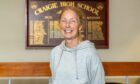PE teacher Mary Johnstone in front of Craigie High dux board. She speaks about schools closure.