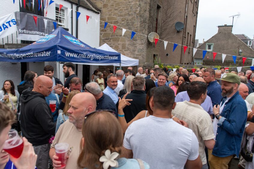 People drinking and chatting at a beer festival. 