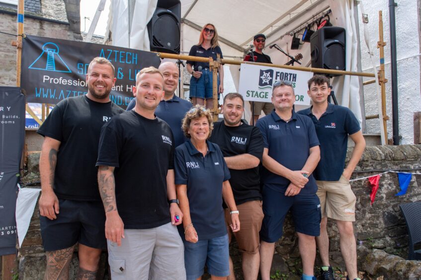 RNLI volunteers posing at a beer festival. 