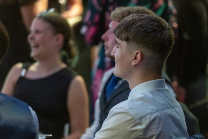 a young man smiling at the event