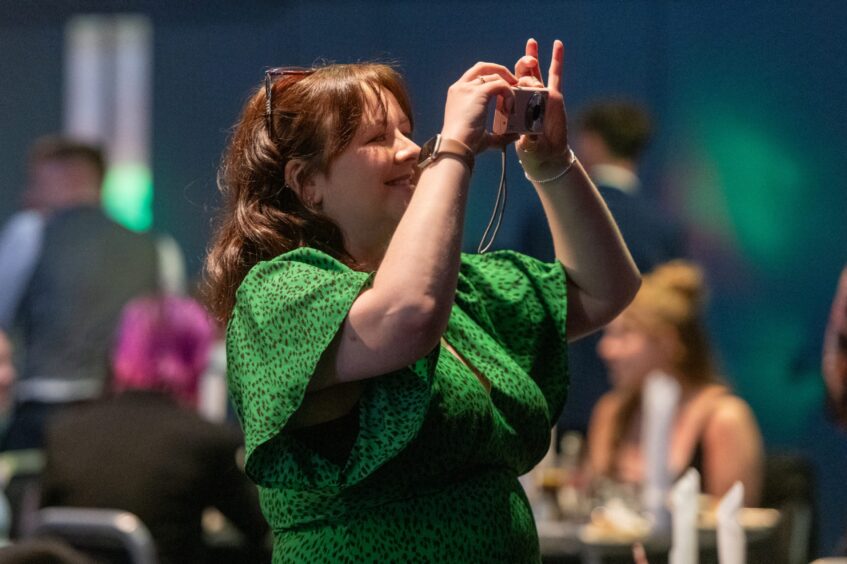 A woman holds a camera