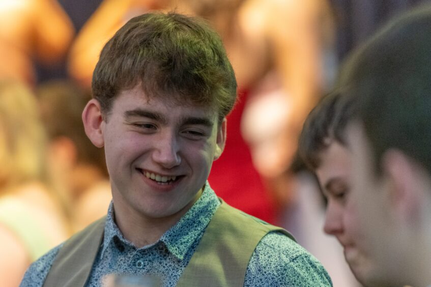 A young man smiling at the event.