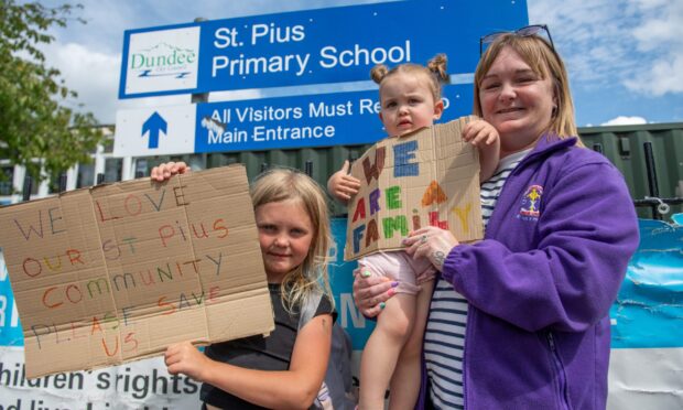 Ayla Squire (pupil at the school) and Rosie Brady (attends the school nursery) with their grandmother, Marion Swan who is leading the campaign to save the school, St Pius Primary School,