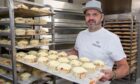 Jonathon Clark holding a tray of pies.