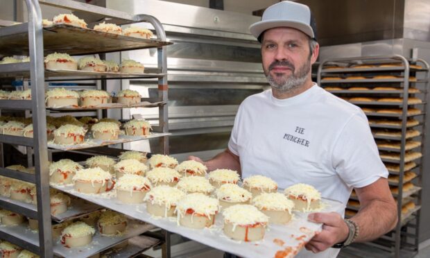 Jonathon Clark holding a tray of pies.
