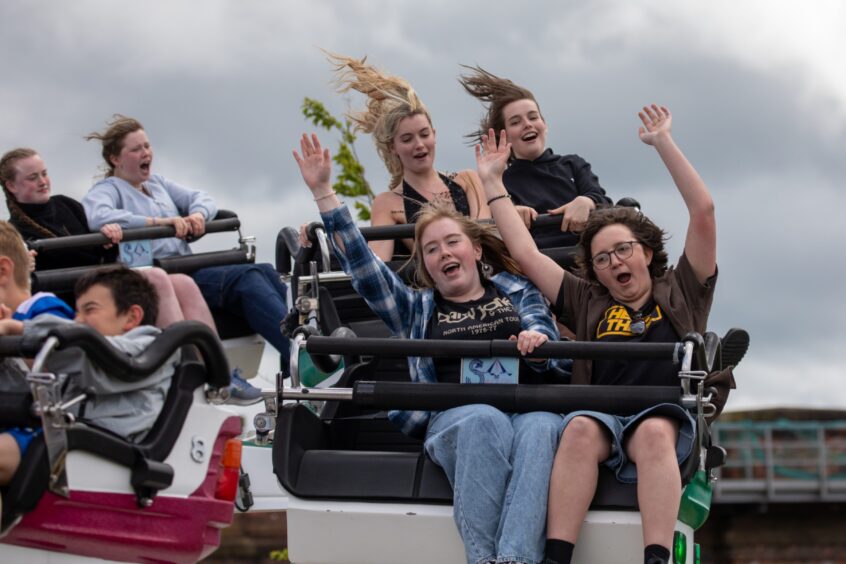 Young people on a funfair ride at Westfest